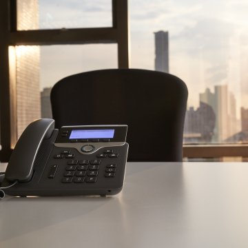 voip services phone.com desk chair window office phone on desk